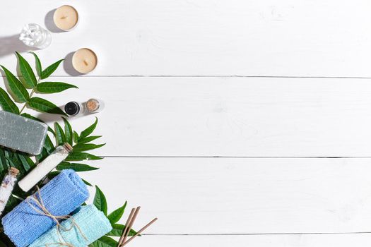 Spa set with towels and soap on white wooden background top view. Copy space. Still life. flat lay