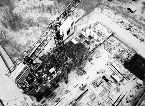 Construction Crane from Above. tower crane on the construction site aerial view. Aerial View Of construction site with crane. Construction workers are building. Top view.