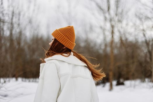 Happy young woman Walk in winter field landscape outdoor entertainment There is a lot of snow around. High quality photo