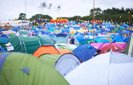 Shot of a campsite filled with many colorful tents at an outdoor festival.