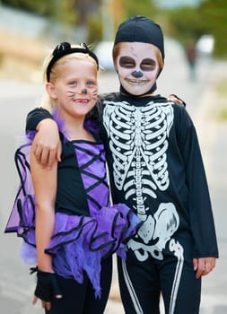 Cute boy and girl dressed up for Halloween.