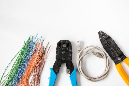 Internet cable and tools on the white background, high angle view