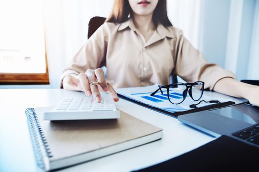 economists and accountants , data analysts are using calculators to calculate budgets and investments using statistical documents and computers to work at their desks