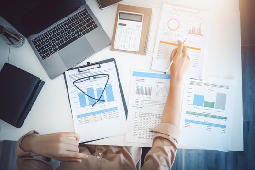 economists and accountants , data analysts are using calculators to calculate budgets and investments using statistical documents and computers to work at their desks