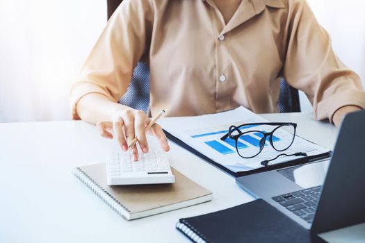 economists and accountants , data analysts are using calculators to calculate budgets and investments using statistical documents and computers to work at their desks