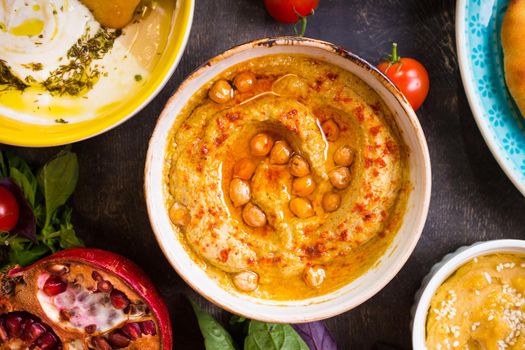 Hummus plate close-up. Hummus, tahini, pitta and buttermilk dip with olive oil. Most famous dishes of middle eastern cuisine