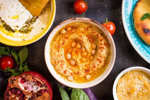 Hummus plate close-up. Hummus, tahini, pitta and buttermilk dip with olive oil. Most famous dishes of middle eastern cuisine