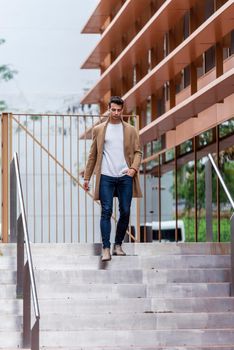 Young man outdoor in winter fashion, wearing woolen jacket in city setting