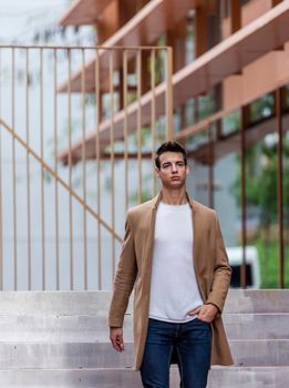 Young man outdoor in winter fashion, wearing woolen jacket in city setting