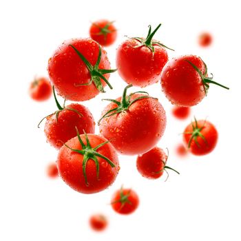 Red tomatoes levitate on a white background.