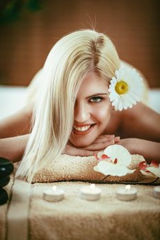 Cute young woman is enjoying during a skin care treatment at a spa. 