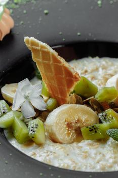 Quinoa porridge with banana, blueberry and pecan nuts for breakfast.