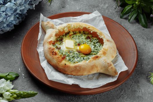 Some khachapuri traditional Georgian homemade cheese and spinach pies on the plate.