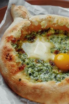 Some khachapuri traditional Georgian homemade cheese and spinach pies on the plate.