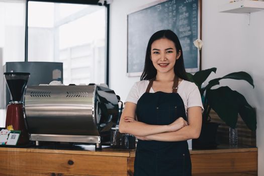 At her cafe, the business owner or barista is taking orders from customers