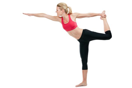 Studio shot of a young woman doing stretch exercises.