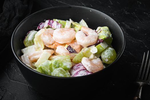 Salad of shrimp avocado, Prawn Waldorf set , with sauce apple and grape, on black stone background