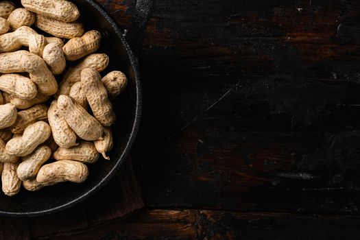 Peanuts serving to make oil, peanut butter set, on old dark wooden table background, top view flat lay, with copy space for text