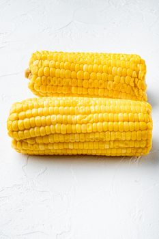 Boiled sweet corn set, on white stone background, with copy space for text