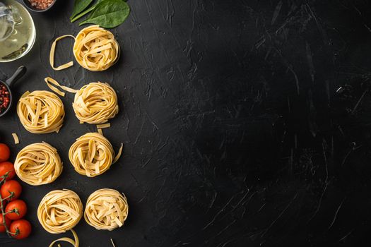 Fettuccine Tagliatelle pasta Italian food ingredients set, on black stone background, top view flat lay, with copy space for text