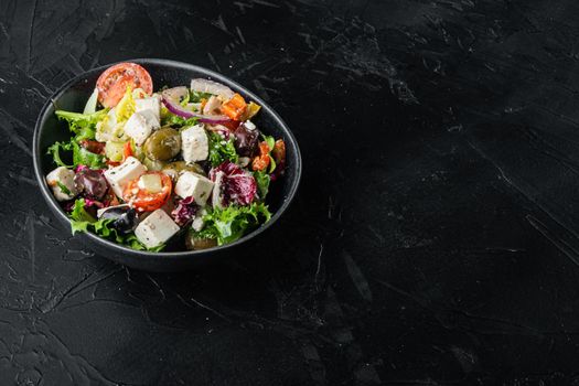 Greek salad with feta cheese and organic fresh olives, on black background with copy space for text