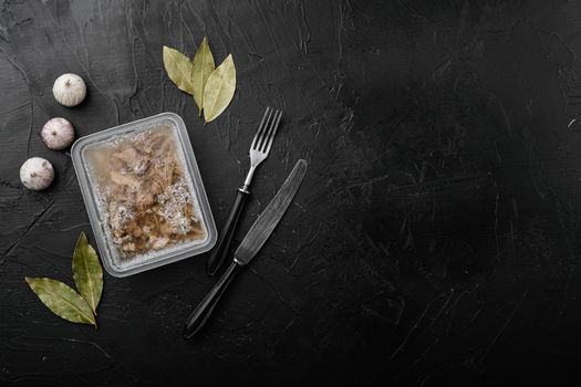 Homemade delicious jelly meat set, on black dark stone table background, top view flat lay, with copy space for text