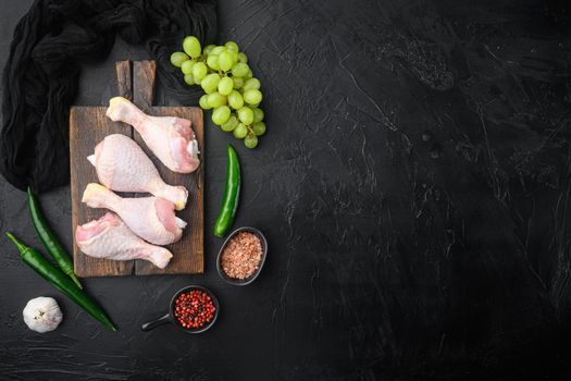 Sweet chicken surprise ingredients set, on wooden cutting board, on black stone background, top view flat lay, with copy space for text