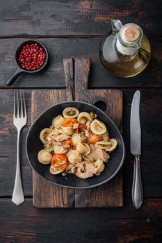 Tuna pasta shells in bowl, on old wooden table, top view