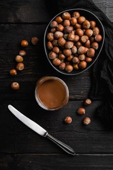 Chocolate spread jar set, on black wooden table background, top view flat lay