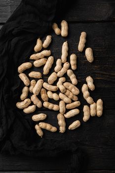 Whole peanut nuts set, on black wooden table background, top view flat lay
