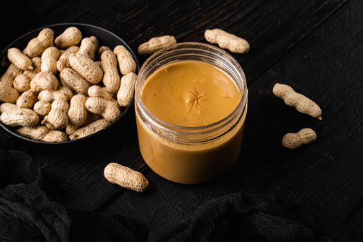 Peanut butter set, on black wooden table background