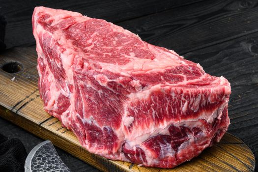 Raw dry aged Kobe Entrecote Steak set, on black wooden table background