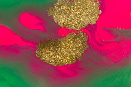 Gold spots on pink and green paints background. Abstract print.