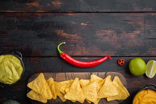 Different dips and sauces for nacho, on old wooden table, top view or flat lay with copy space for text