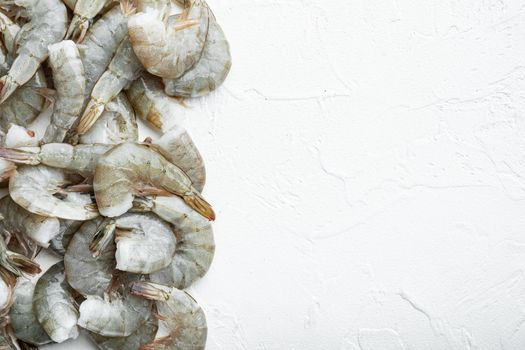 Raw fresh uncooked prawns shrimps set, on white stone surface, top view flat lay, with copy space for text