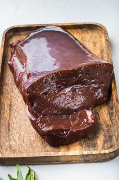 Raw liver on white background.