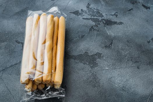 Breadsticks, with olive oil, on gray background with copy space for text