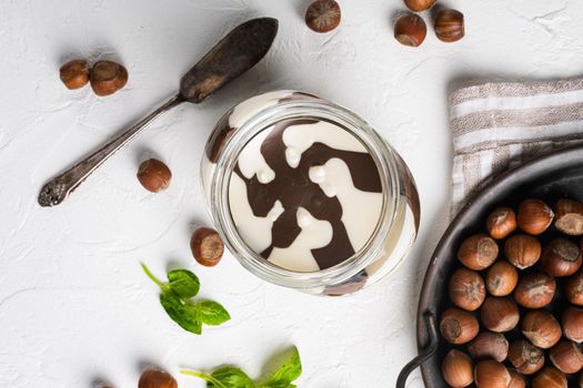 Chocolate spread jar set, on white stone table background, top view flat lay