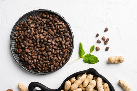 Cedar wild organic nut set, on white stone table background, top view flat lay, with copy space for text