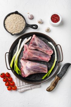 Raw lamb shanks meat set, on white stone table background, top view flat lay