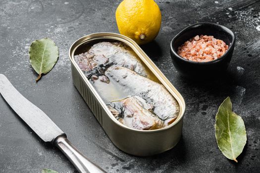 Tin can of seafood sardines fish set, on black dark stone table background