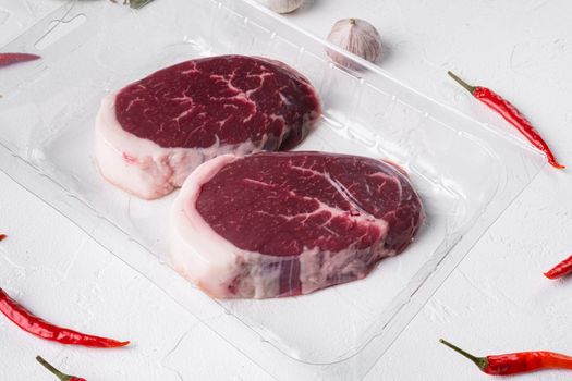 Beef steak vacuum Packed set, on white stone table background