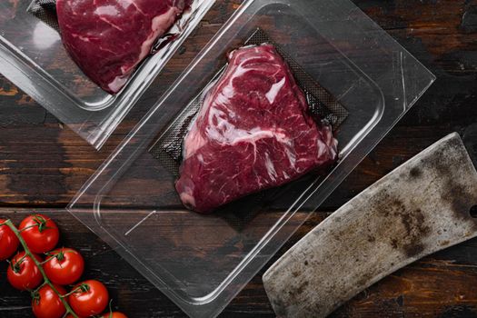 Market pack with raw rump beef steak set, on old dark wooden table background, top view flat lay