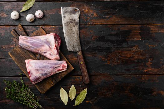 Uncooked lamb shank set, on old dark wooden table background, top view flat lay, with copy space for text