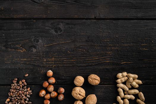 Nuts mix, peanut, walnut, pine nuts and hazelnut set, on black wooden table background, top view flat lay, with copy space for text