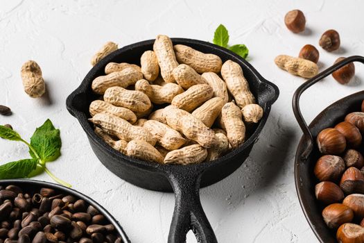 Dried peanuts. Tasty groundnuts set, on white stone table background
