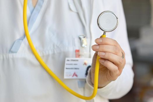 Female doctor holding a stethoscope. Concept for health and medicine. Hospital background.