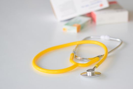 Stethoscope with medication on the table. Concept for health and medicine. Hospital background.