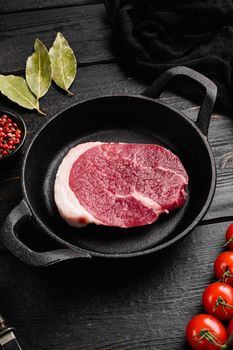 Raw tenderloin steak set, on black wooden table background