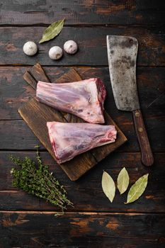 Raw Mutton shanks meat set, on old dark wooden table background, top view flat lay, with copy space for text